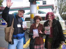 A BBT volunteer posing with two happy customers
